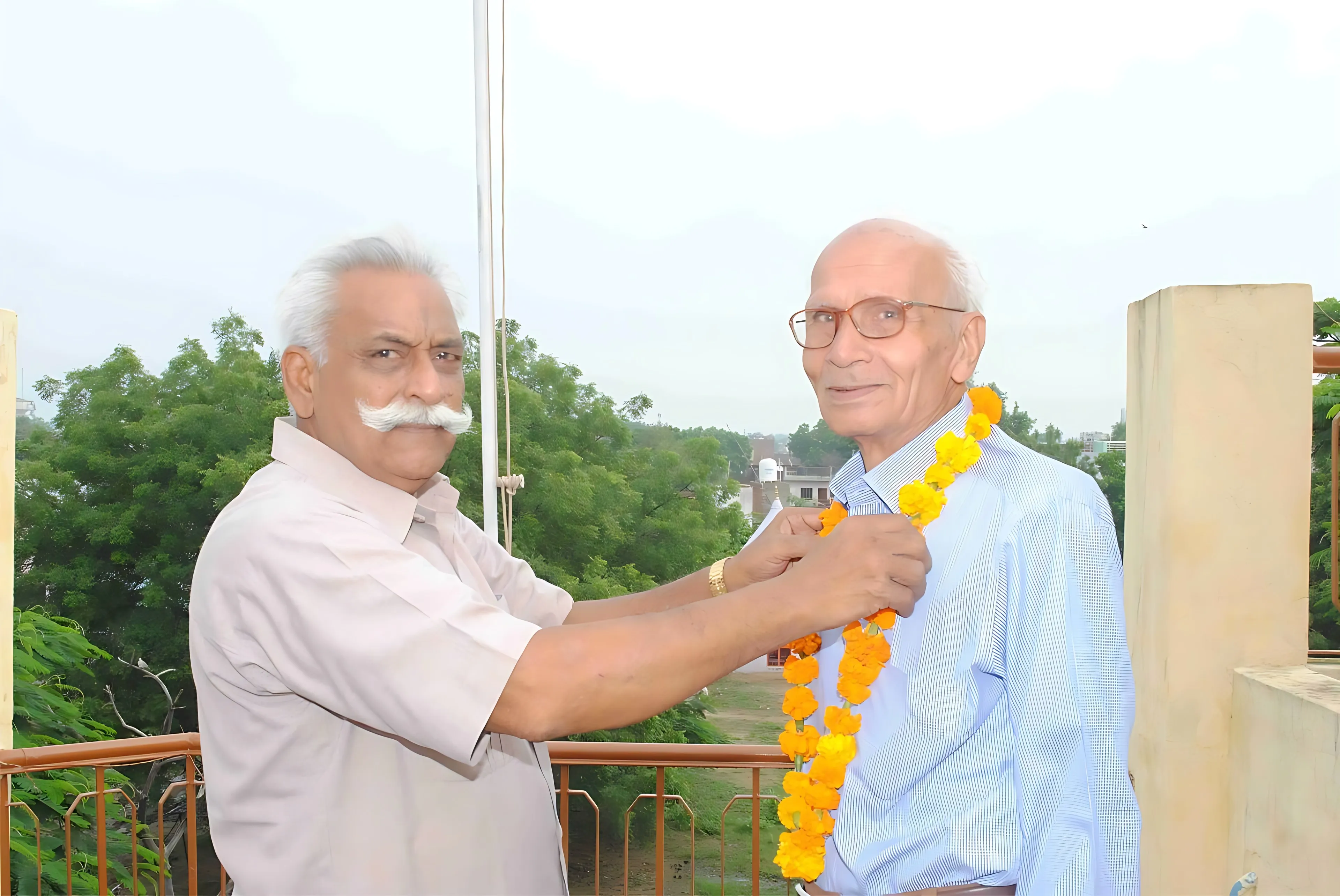 A guest being welcomed with a garland at a school function